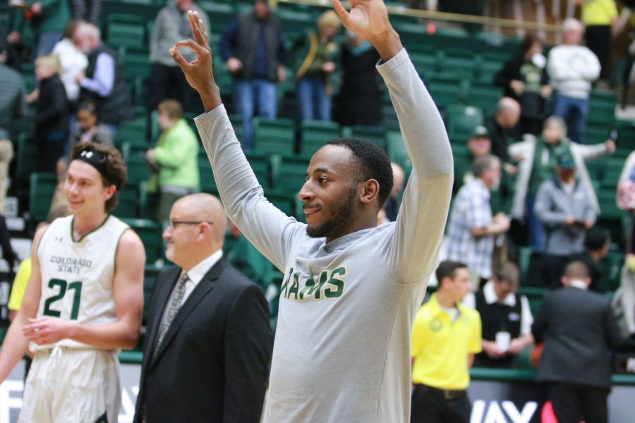 J.D.  Paige (22) holdes up three after the Rams defeat the Golden Lions. J.D. had 4 threes in the game and had 32 points. The Rams won 92-67. (Devin Cornelius | Collegian)