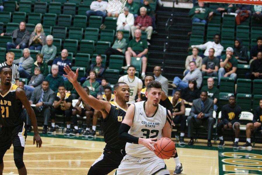 Nico Carvacho (32) looks to pass as the Rams battle the Golden lions at home. The Rams win 92-67(Devin Cornelius | Collegian)