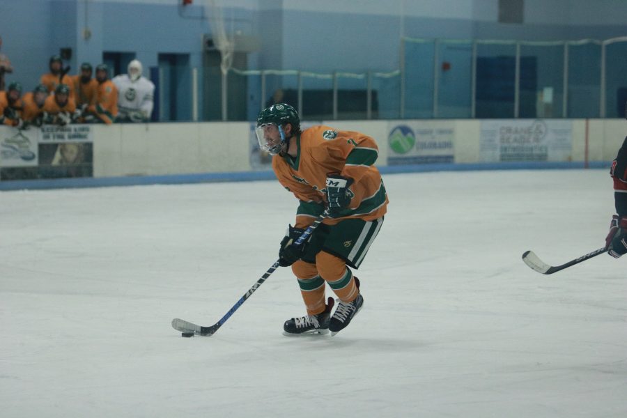 John Tower (7) looks the pass the puck down the rink while the Rams battle the Utes. The Rams win 6-3. (Devin Cornelius | Collegian)