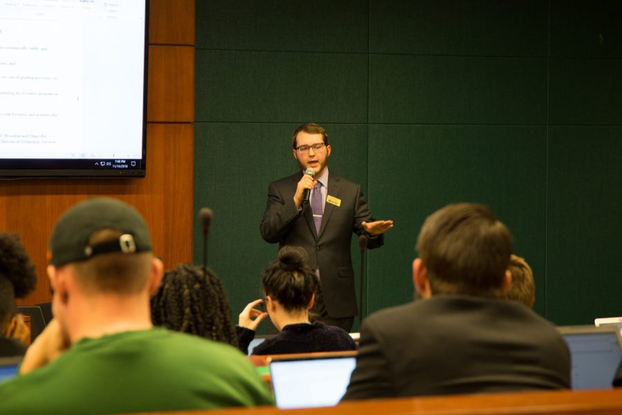Josh Lindell, presents a resolution to extend free student printing across campus, which would add ads to student papers to reduce cost. (Anna Baize | Collegian)
