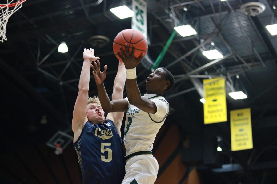 Kendle Moore (3) jumps and shoots a layup while being defended by a MSU player. CSU wins 81-77. (Devin Cornelius | Collegian)