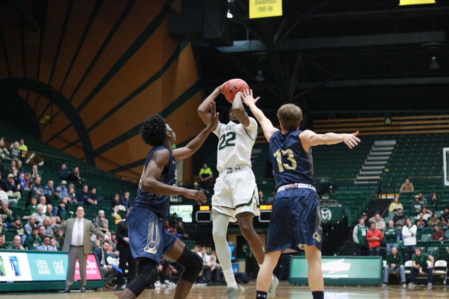 J.D. Paige (22) shoots a fadeaway from the three point line while garded by two MSU defenders, as CSU battles MSU at home. CSU defeats MSU 81-77. (Devin Cornelius | Collegian)