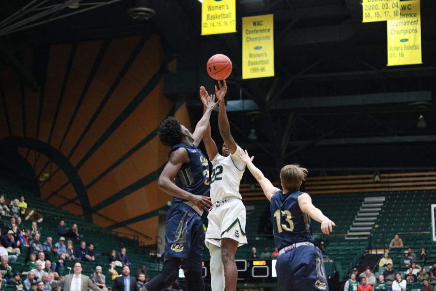 J.D. Paige (22) shoots a fadeaway from the three point line while garded by two MSU defenders, as CSU battles MSU at home. CSU defeats MSU 81-77. (Devin Cornelius | Collegian)