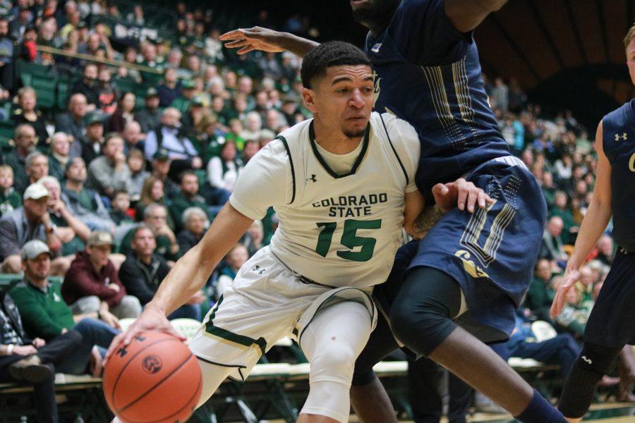 Anthony Masinton-Bonner drives past a defender towards the basket during CSU's game against MSU. CSU wins 81-77. (Devin Cornelius | Collegian)