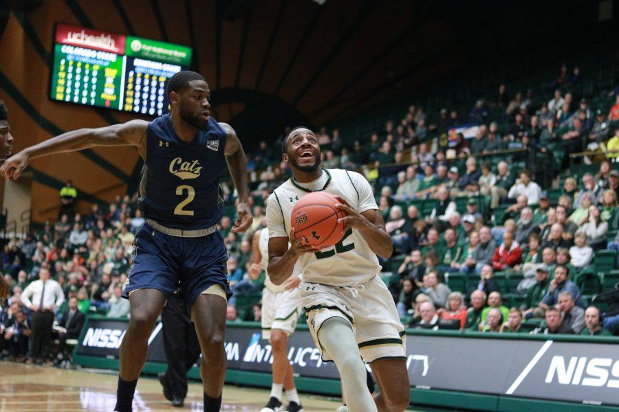 J.D. Paige (22) smiles as drives past a defender and jumps up for a layup as CSU takes on MSU at home. CSU wins 81-77. (Devin Cornelius | Collegian)