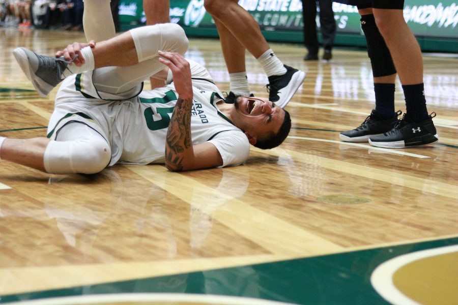 Antony Masinton-Bonner (15) clutches his right leg after some contact with a MSU player. Masinton-Bonner would return later in the game. CSU beats MSU 81-77.  (Devin Cornelius | Collegian)