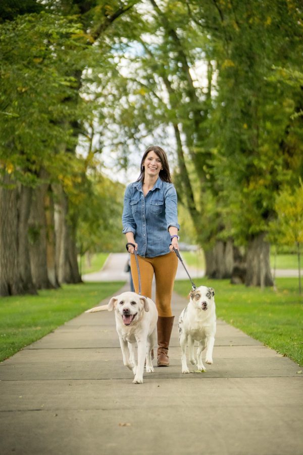 Lily_Edwards-Callaway and her two dogs on the Colorado State University Oval, October 3, 2018. Students in the Doctor of Veterinary Medicine Program are now required to take an animal welfare class taught by assistant professor of livestock behavior and welfare Lily Edwards-Callaway. (Photo courtesy of the College of Agricultural Sciences)