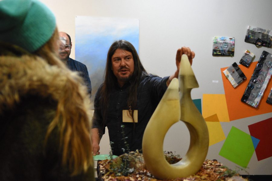 Patrick Price talking about his piece The Visitor that was on display at the Self Identity Fall Art Exhibition, hosted by Saxon Art and Design Nov. 30, 2018. (Matt Tackett | Collegian)