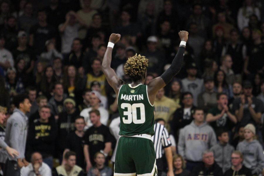 Kris Martin (30) raises his arms in the air in celebration when J.D. Paige (22) jumps dunks the basketball. The Rams lost to the Buffaloes 86-80 on Dec. 1st in Boulder. (Matt Begeman | Collegian)