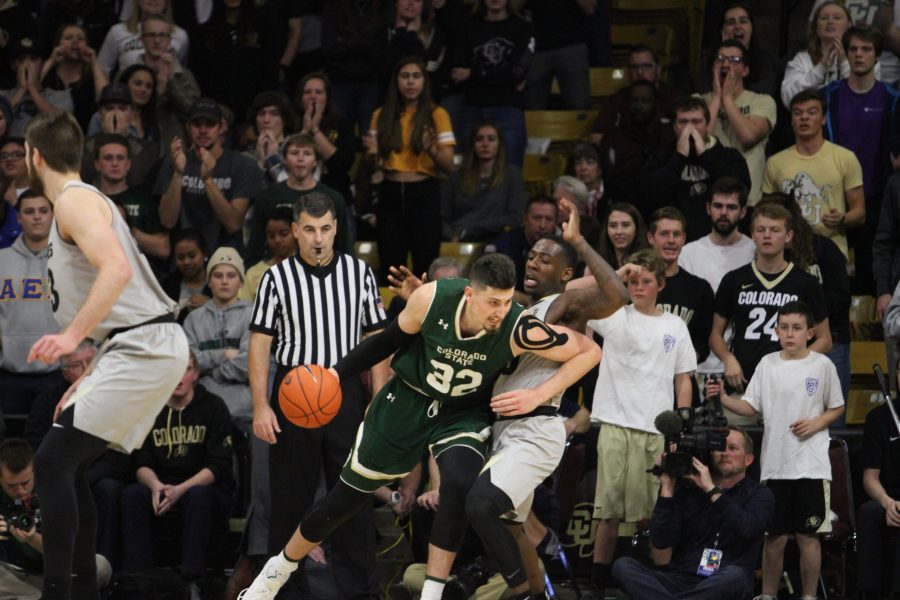 Forward/Center Nico Carvacho (32) drives to the basket and runs into a CU player. The Rams lost to the Buffaloes 86-80 on Dec. 1st in Boulder. (Matt Begeman | Collegian)