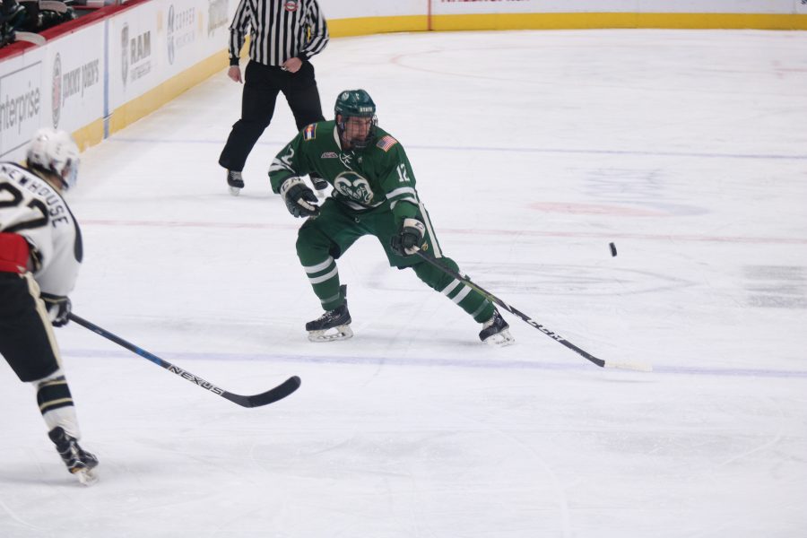 Tyler Nelson (12) prevents CU from clearing the puck, during the Rams game against the Buffs. CSU loses 8-3.(Devin Cornelius | Collegian)