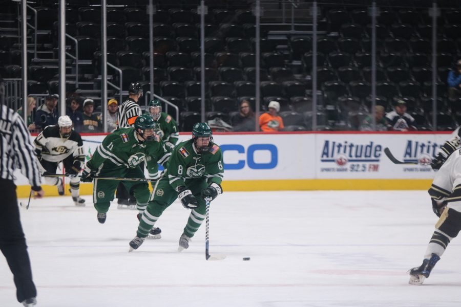 Samuel Cote (8) looks to pass the puck as CSU battles CU. The Buffs win 8-3. (Devin Cornelius | Collegian)