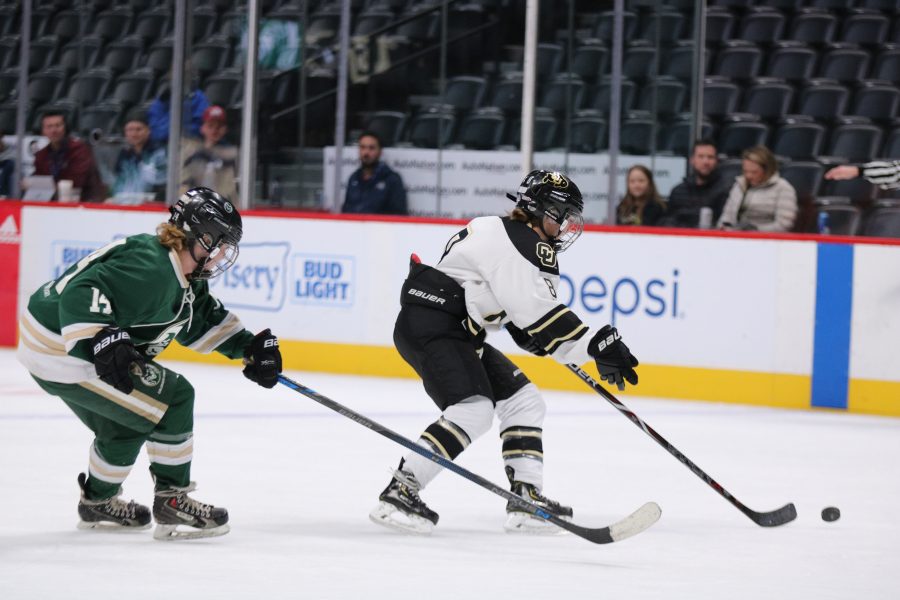 Kristen Perry (14) attempts to steal the puck from a CU player as the Rams battle against the Buffs at the Pepsi Center. CSU loses 9-0. (Devin Cornelius | Collegian)