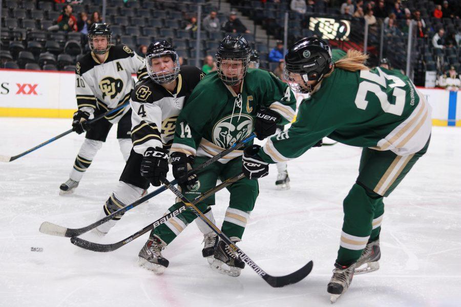 Kristen Perry (14) and Emily Kruger (25) battle buff defenders for the puck during their game against CU. CSU loses 9-0. (Devin Cornelius | Collegian)
