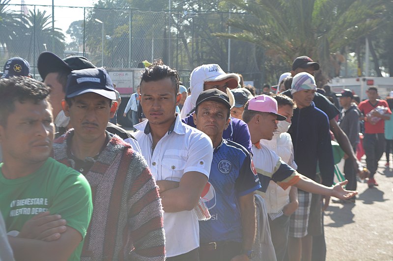 Line of migrants from Honduras, El Salvador and Guatemala waiting for breakfast in Ciudad Deportiva Magdalena Mixhuca temporary camp, Mexico City. image courtesy of Wikimedia commons