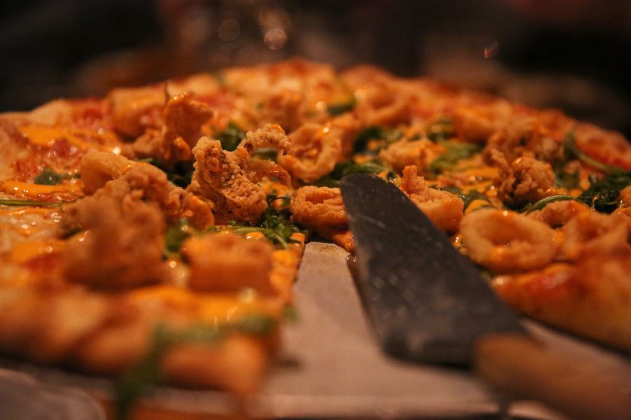 A calamari pizza sits at the table of Mark Kohrmann and his family at Nick's Italian restaurant on Jan. 23. Kohrmann is employed by the United States Department of Agriculture, but has been unable to work due to the federal government shutdown. Nick's was holding an event where federal employees could receive a free meal with a valid government ID. (Forrest Czarnecki | Collegian)