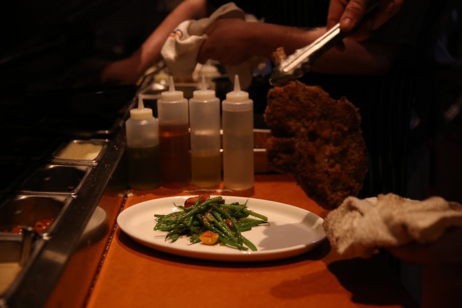 Cooks put together a meal on the night of Jan. 23 at Nick's Italian restaurant. Nick's was holding an event where federal employees could receive a free meal with a valid government ID. (Forrest Czarnecki | Collegian)