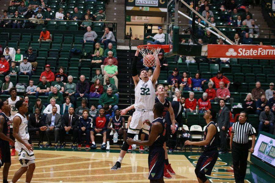 Nico Carvacho (32) dunks the ball after being assisted by Hyron Edwards (0), as the Rams battle the Bulldogs at home. CSU wins 75-64.  (Devin Cornelius | Collegian)