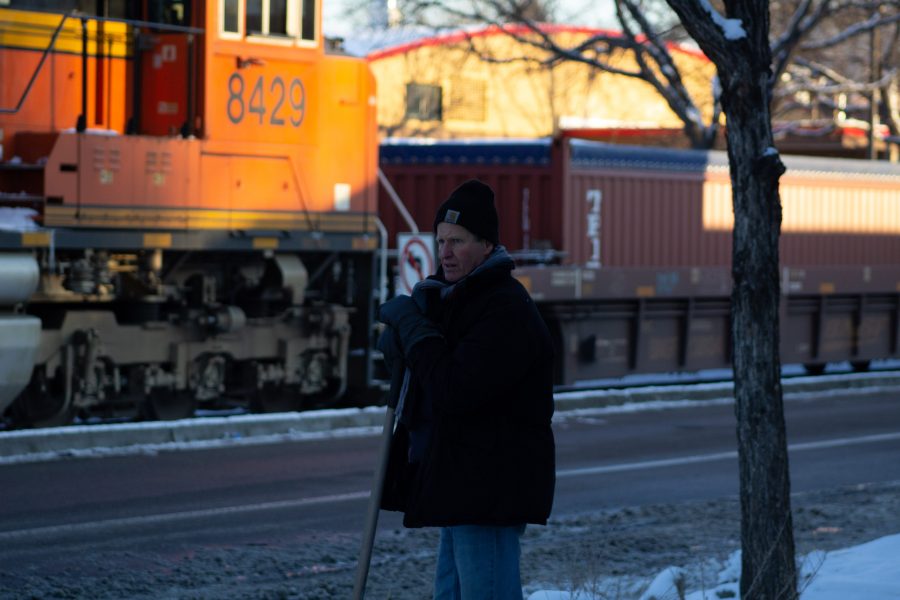 Greg Taylor looks at a stopped freight train near the intersection of Mason and Laurel streets following a train and pedestrian collision at 2:57 p.m. Feb. 7. One fatality was confirmed by Fort Collins Police Services. (Austin Fleskes | Collegian)