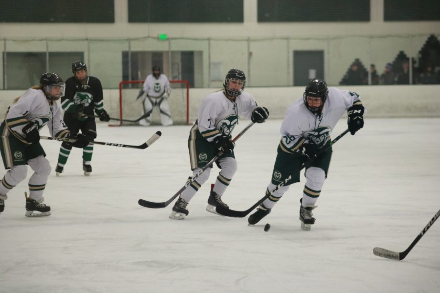 Lee-Ann Wengenroth (28) brings the puck down the ice, followed by Alyssa Schmidt (7) and Allie Litzinger (16) (Devin Cornelius | Collegian)