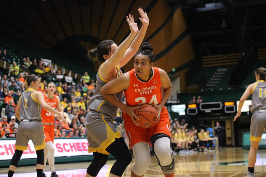 Liah Davis (34) drives in under the basket and looks to shoot, during the Border War game. The Rams lose to the Cowgirls 60-49. (Devin Cornelius | Collegian)