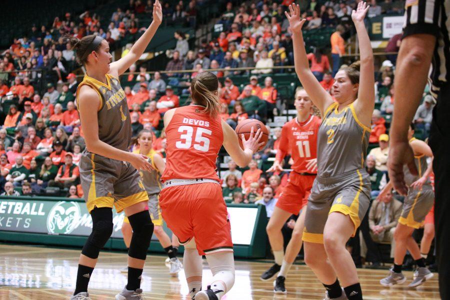 Lore Devos (35) passes the ball to Lena Svanholm (11) as the Rams take on the Cowgirls, at home. CSU falls short 60-49. (Devin Cornelius | Collegian)