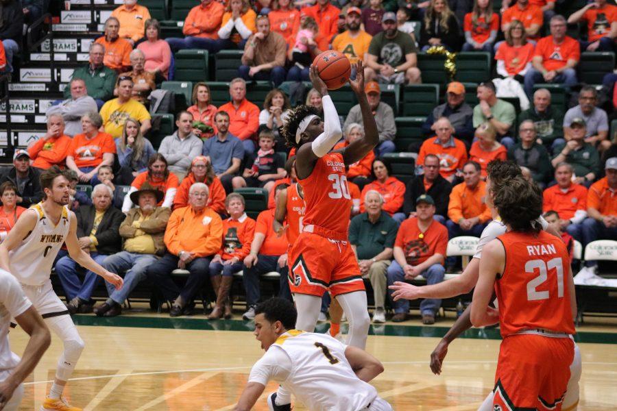 Kris Martin (30) drives through traffic and shoots a layup, as CSU battles WYO. The Rams wim 83-48. (Devin Cornelius | Collegian)