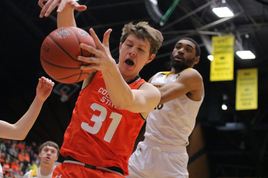 Adam Thistlewood (31) fights for possession of the ball, as CSU battles WYO. The Rams beat the Cowboys 83-48. (Devin Cornelius | Collegian)