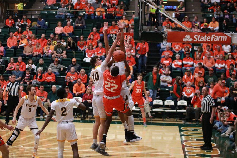 J.D. Paige (22) shoots a layup in traffic, as the Rams battle the Cowboys. CSU beats WYO 83-48. (Devin Cornelius | Collegian)