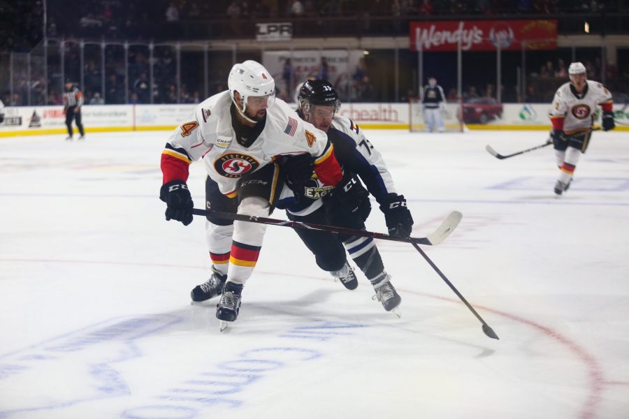 Eagles forward Travis Barron attempts to push past a Stockton defender during the game Nov. 14 at the Budweiser Events Center. (Photo Courtesy of Colorado Eagles)