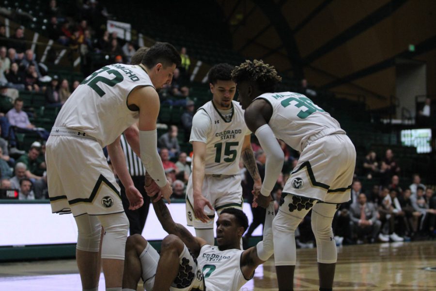 The Rams help up their teammate, Hyron Edwards, after taking a fould driving up the lane. (Joshua Contreras | Collegian)