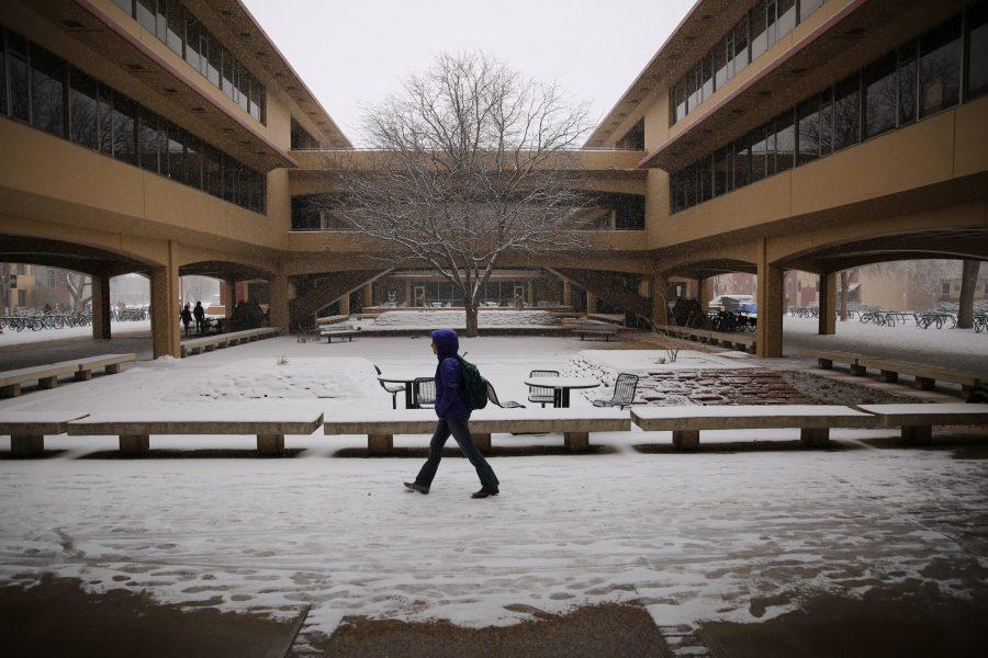 A Colorado State University student walks through the courtyard underneath the Clark B wing while it snows on Feb. 6. Several inches of snow fell on Fort Collins Wednesday morning. No more snow is in the forecast for the rest of the week, although temperatures may stay below 40 degrees Fahrenheit for the next few days, according to the National Weather Service. (Forrest Czarnecki | Collegian)