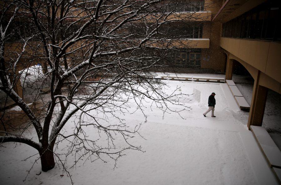 A pedestrian walks through the courtyard underneath the Clark B wing while it snows on Feb. 6. Several inches of snow fell on Fort Collins Wednesday morning. No more snow is in the forecast for the rest of the week, although temperatures may stay below 40 degrees Fahrenheit for the next few days, according to the National Weather Service. (Forrest Czarnecki | Collegian)
