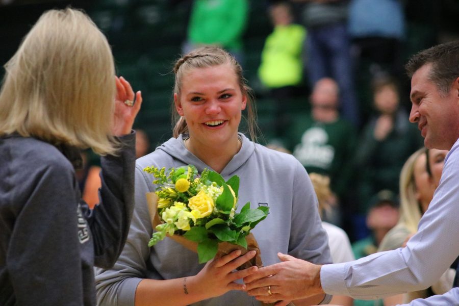 Tatum Neubert (44) receives flowers and a standing ovation before Colorado State's Senior day game. (Devin Cornelius | Collegian)