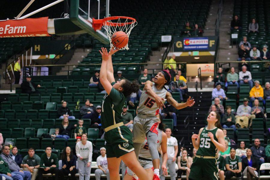 Myanne Hamm(21) drives under the basket and shoots a layup, during Colorado State's game against New Mexico, at home. CSU falls 79-56.(Devin Cornelius | Collegian)