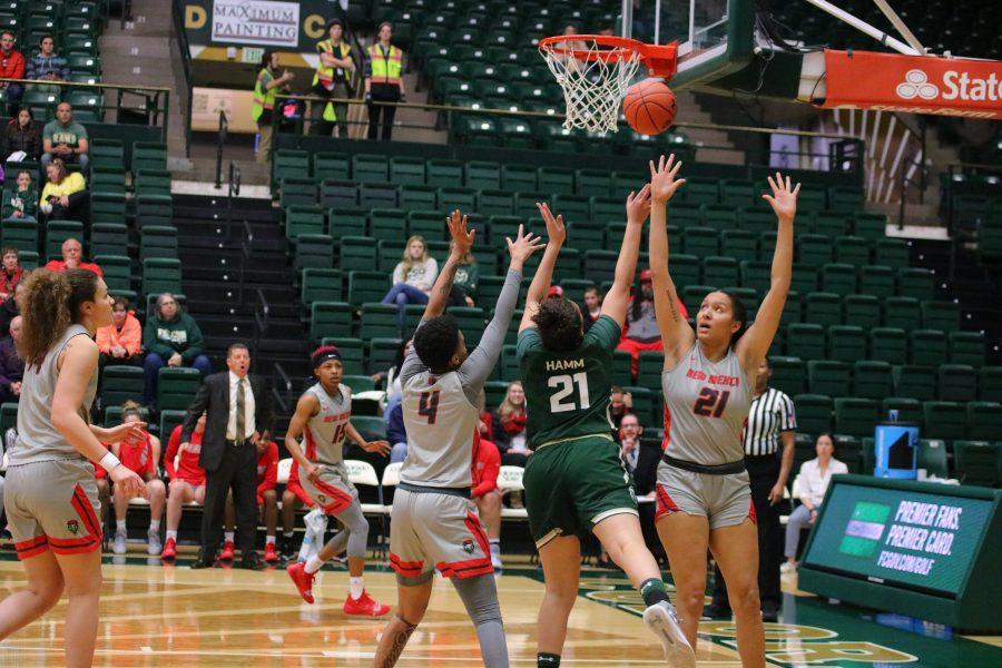 Myanne Hamm(21) shoots a layup while guarded by opposing players, as the Rams take on the Lobos. CSU loses 79-56. (Devin Cornelius | Collegian)