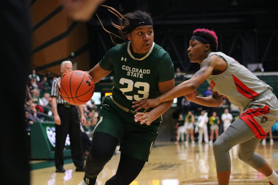 Grace Colaivalu (23) drives past a defender as Colorado State University takes on New Mexico at home March 2. The Rams lost 79-56. (Devin Cornelius | Collegian)