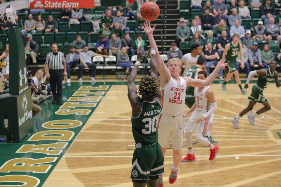 Kris Martin (30) shoots from the three point line while a defender attempts to block the shot, during the CSU game against UNLV. The Rams fall 65-60. (Devin Cornelius | Collegian)