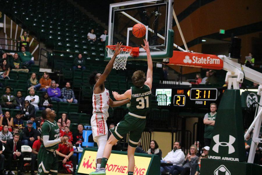 Adam Thistlewood(31) drives in and shoots a layup while a defender attempts to block his shot, as CSU takes on UNLV at home during senior day. CSU falls 65-60. (Devin Cornelius | Collegian)
