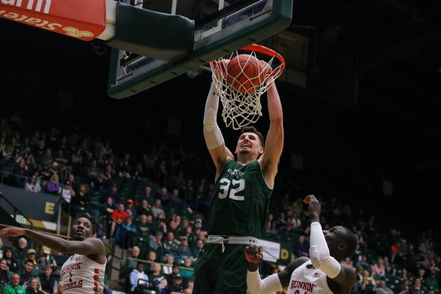 Nico Carvacho(32) dunks the ball on a UNLV defender, as CSU takes on UNLV in a senior day game at home. CSU falls to UNLV 65-60. (Devin Cornelius | Collegian)