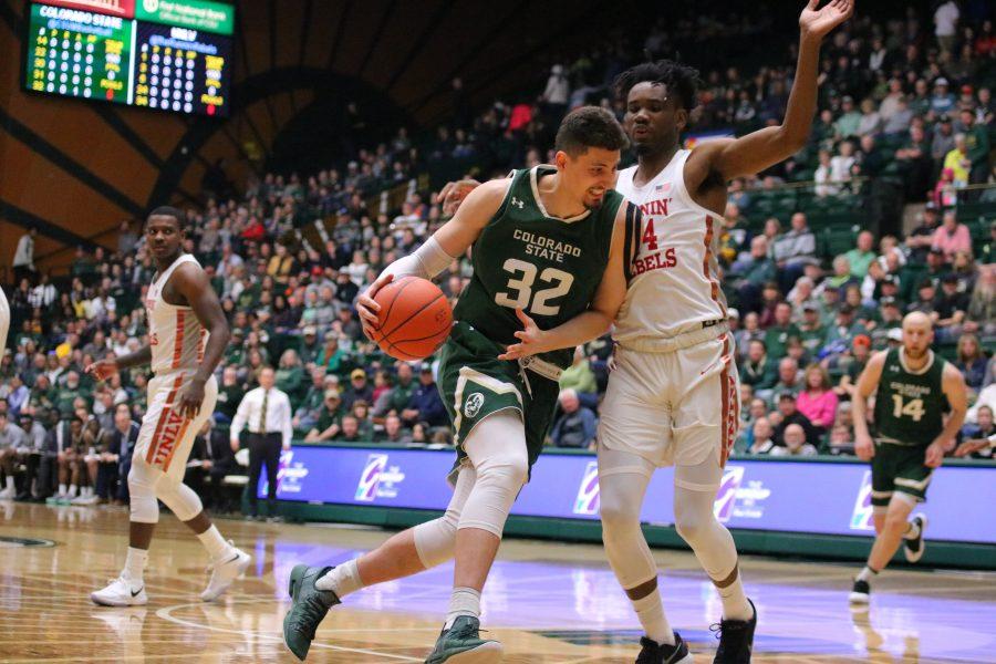 Nico Carvacho (32) drives towards the basket while being guarded by a defender, as CSU battles UNLV at home. CSU loses 65-60. (Devin Cornelius | Collegian)