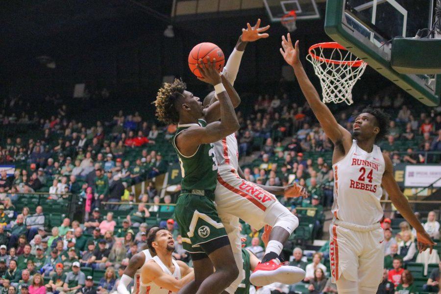 Kris Martin (30) drives up towards the basket and shoots while being guarded, during CSU's senior day home game against UNLV. CSU falls 65-60. (Devin Cornelius | Collegian)