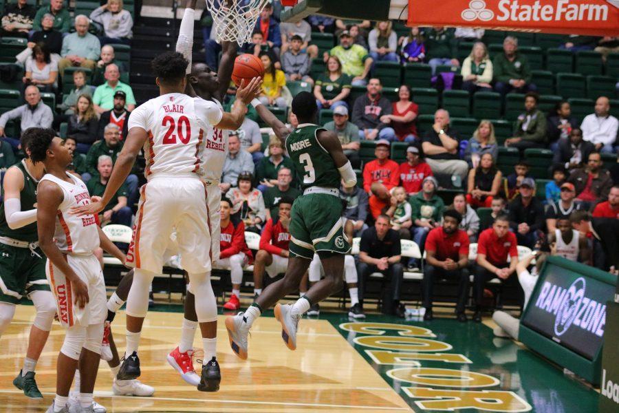 Kendle Moore(3) attempts a behind the back layup after driving under the basket, during CSU's senior day home game against UNLV. The Rams fall 65-60. (Devin Cornelius | Collegian)