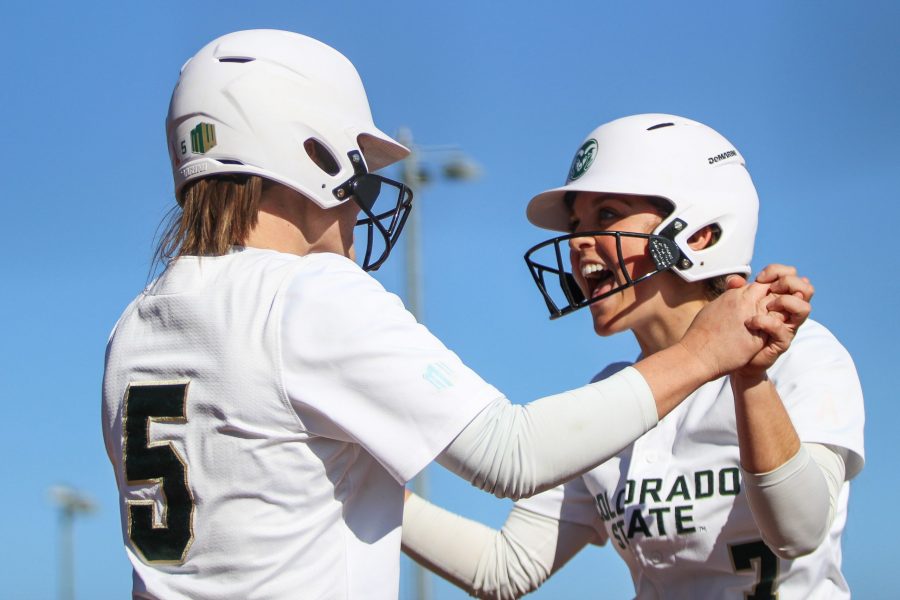 Danni Klein and Haley Donaldson celebrate after scoring a run during the game against Fresno State. (Ashley Potts | Collegian)