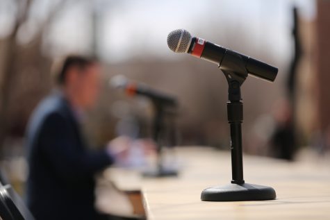 A microphone sits on a table before the start of the ASCSU election debate March 27 in the Plaza. (Forrest Czarnecki | Collegian)
