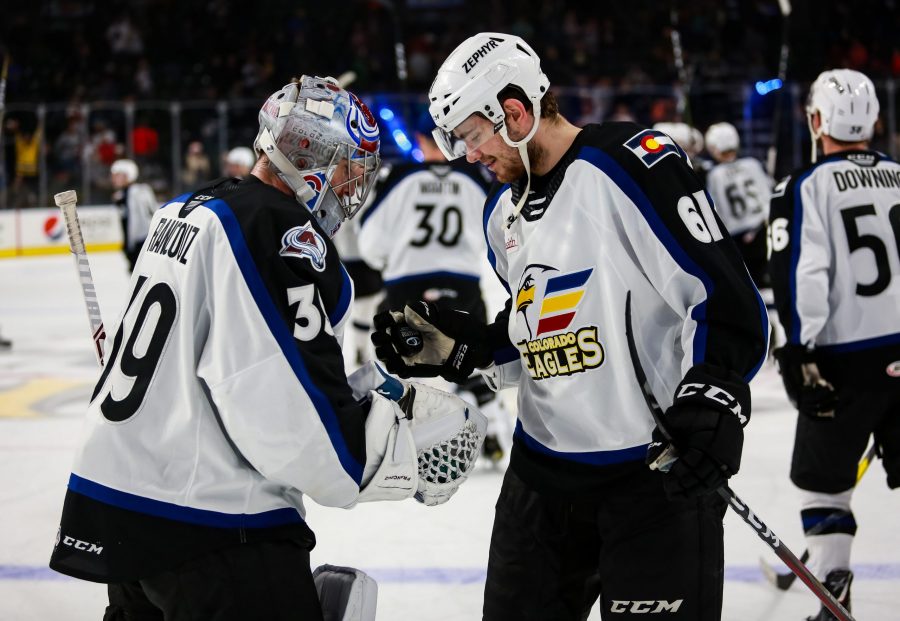 Martin Kaut gives the game puck to Pavel Francouz after his first shutout of the season. (Photo Courtesy of Colorado Eagles)