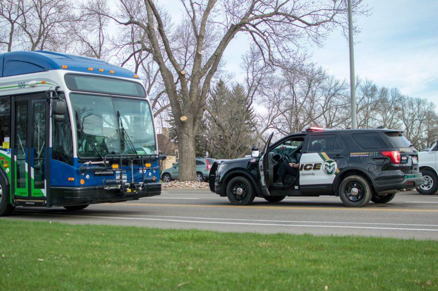 A police cruiser is stopped next to a Transfort bus that was involved in a collision on Plum St. Tuesday April 9, 2019. (AJ Frankson | Collegian)