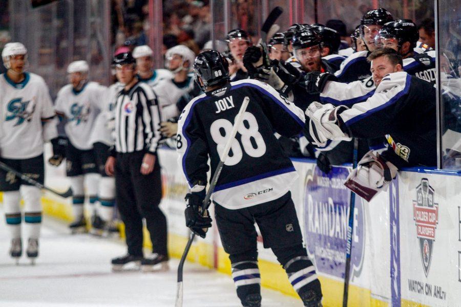 Colorado Eagles forward Michael Joly high fives his teammates on the bench after scoring a goal in the second period of the game against San Jose. The Eagles fell to the Barracuda 3-1. (Photo Courtesy of Colorado Eagles)