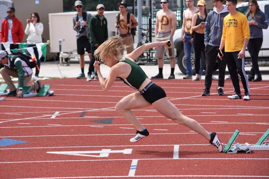 Marybeth Sant launches from the start blocks in the 4x100m relay on April 14, 2019. Gale and her team would complete the race with a new school record and in first place. (Alyse Oxenford | Collegian)