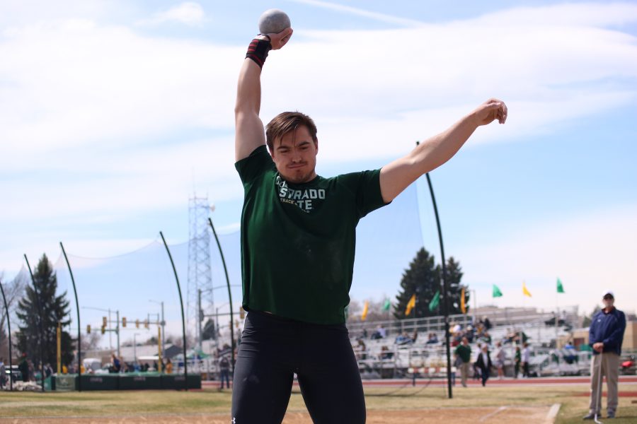 Weston Wright raises the shot put ball before he throws, during the Doug Max Invitational. Wright placed seventh in the event (Devin Cornelius | Collegian)